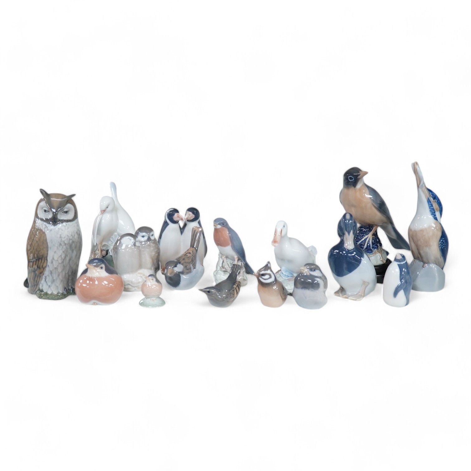 A collection of sixteen Royal Copenhagen models of birds. Tallest a Kingfisher, 18cm high. Condition - the robin is chipped on the tail the rest appear good